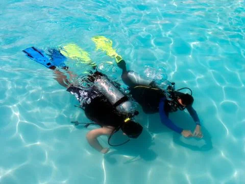 A boy taking scuba diving lessons in the caribbean resort. Stock Photos