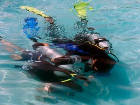 A boy taking scuba diving lessons in the caribbean resort. Stock Photos