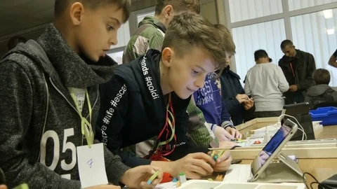 Boy taking some details to make a robot Stock Footage 81357745