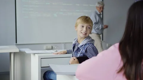 Boy talking with classmate during programming lesson Stock Footage 142493285