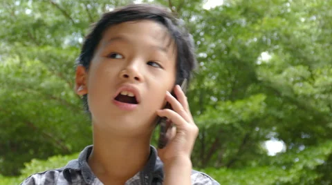 Boy talking on mobile phone Stock Footage 64109357