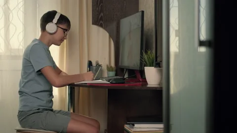 Boy talking on zoom with teacher and studying at home. Stock Footage 236640044