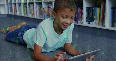 Boy tapping tablet in library, with floating green binary code representing Stock Footage 309102835