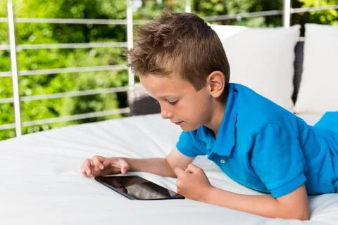 Boy tapping on tablet Stock Photos