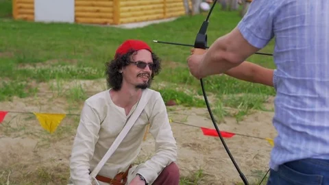 Boy is taught to shoot from the bow Stock Footage 82408910