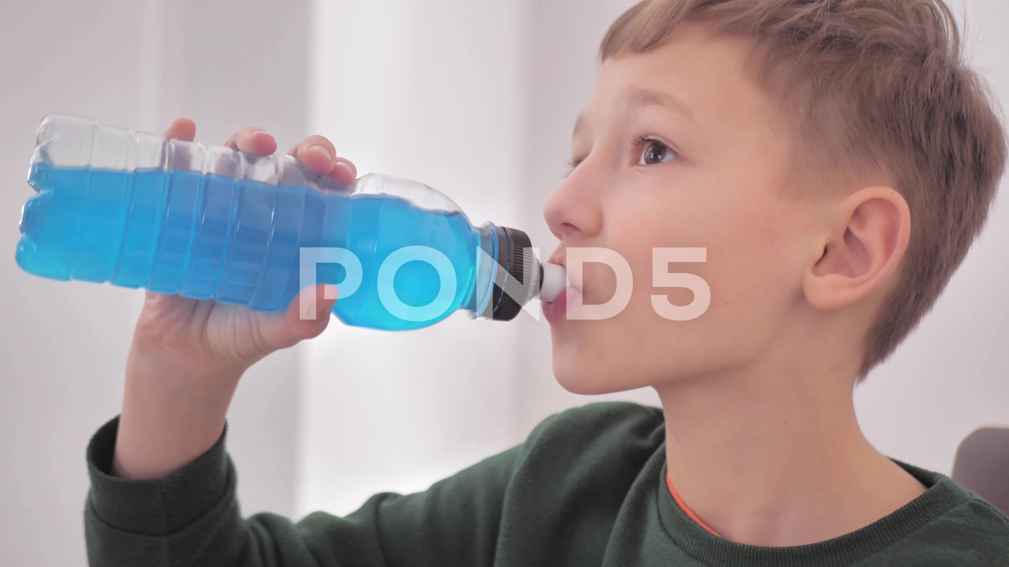 Teen boy drinks water from a bottle, Stock Video
