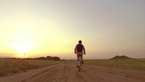 Boy teenager riding a bicycle. Boy teenager riding a bicycle goes to nature Stock Footage