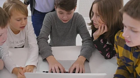 Boy teenager using notebook for study new computer program together classmates Stock Footage 83876775