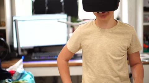 Boy ten years old using virtual reality helmet standing in his room. close up Stock Footage 307490722