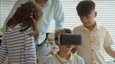 Boy Testing Application in AR Glasses during Group Class with Teacher Stock Footage 280543382