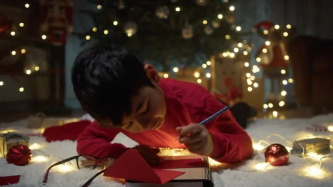 Boy thinking about writing Christmas letter Stock Footage 256102943