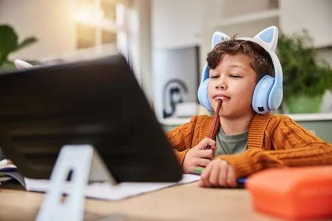Boy, thinking and tablet in home for learning, virtual class and student Stock Photos