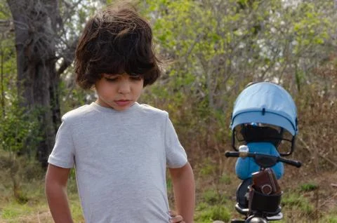 Boy thinking what to do in the forest Stock Photos