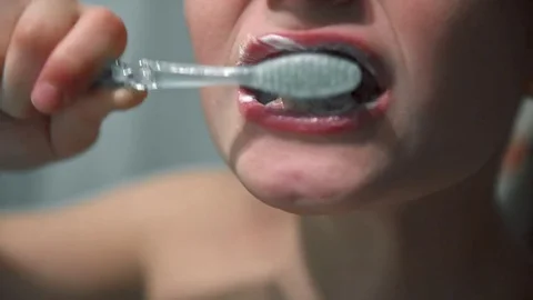 The boy thoroughly brushes his teeth in the bathroom 動画素材 85117995