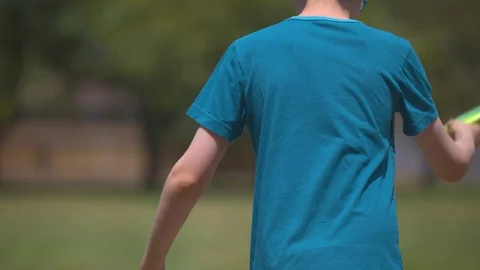 Boy Throwing Disc and Watching it Land Stock Footage 91624964