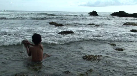 Boy throwing rock at Beach Stock Footage 637023