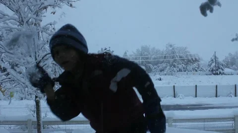 Boy throwing snow Stock Footage 11633926