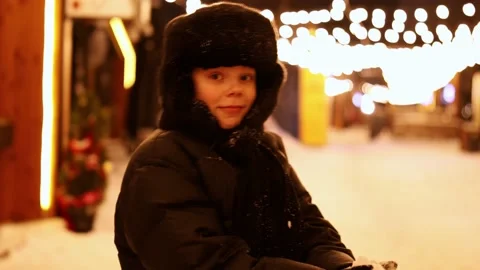 Boy Throwing Snow In Winter At Night, Light Bulbs. Throws Snow. Stock Footage 229835138
