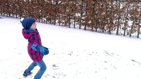 Boy throwing a snowball Stock Footage 86971061
