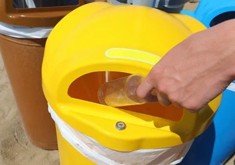 Boy throws away used glass bottle special container Stock Photos