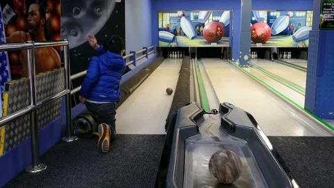 Boy throws bowling ball to beat skittles Stock Footage 70168379