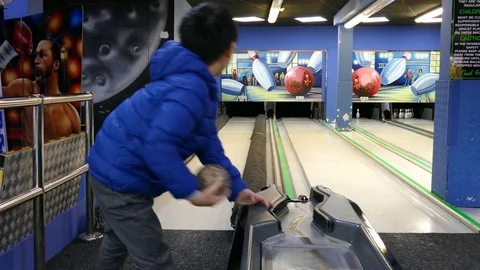 Boy throws bowling ball to beat skittles Stock Footage 70169899