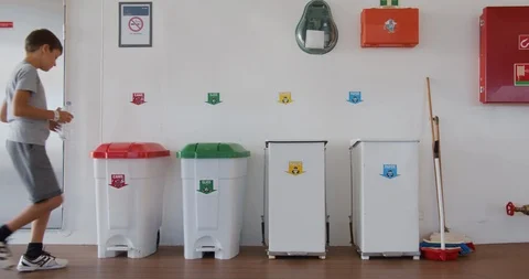 Boy throws a plastic bottle into the right trash can. Recycling plastic, proper Stock Footage 118248273