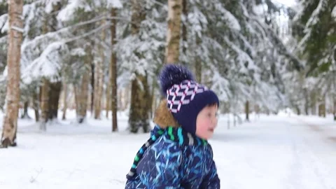 The boy throws snow and laughs . Happy childhood. Winter video picture. Stock Footage 167896933