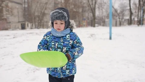 Boy throws snow at the camera on winter background. Stock-Footage 85298429