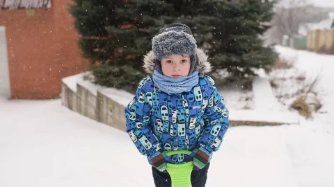 Boy throws snow at the camera on winter background. Stock Footage 85298813