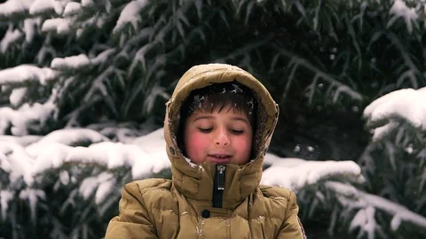 The boy throws snow into his face and laughs Stock Footage 87309542
