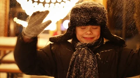 Boy throws snow, in winter, at night Stock Footage 230622615