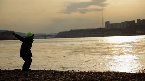 Boy throws a stone in the river. Stock Footage 102565060