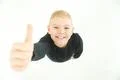 The boy thumbs up to the camera. View from above Photo