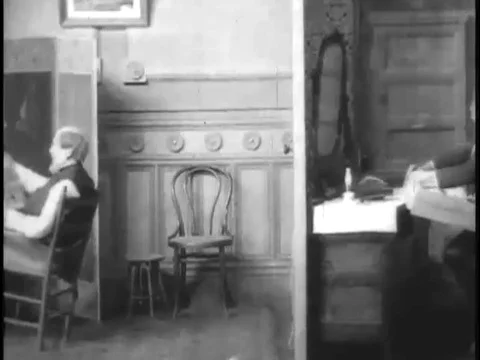 A boy ties a string from a drawer to a chair, causing his mom and grandfather to Stock Footage 74975137