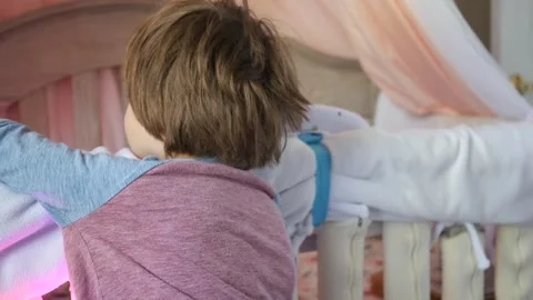 Boy Toddler Looking in Crib Talking to Baby Sister 2 Stock Footage 319968536