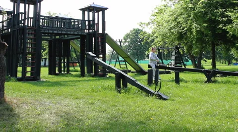 Boy toggles on the see-saw Stock Footage 5270907