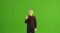 The boy touch the virtual screen on the green background 4k or 4k+ Resolution