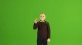 The boy touch the virtual screen on the green background 4k or 4k+ Resolution