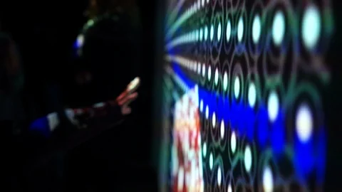 Boy touches a hand to a huge interactive wall. Large glowing screen with glowing Video stock 104954726