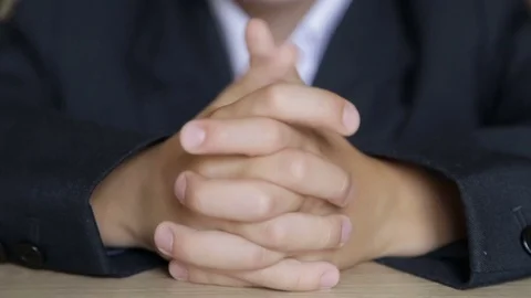 The boy touches his fingers while sitting at his desk Stock Footage 78157221