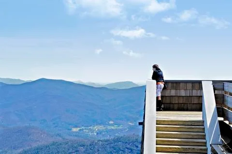 Boy on tower in mountains Stock Photos
