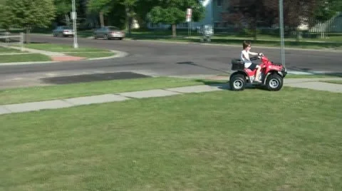 Boy on Toy 4 Wheeler Stock Footage 12571803