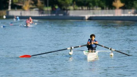 Boy training rowing in a lake Stock Photos