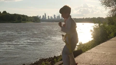 The boy trains hand-to-hand combat at sunset. Against the background of the 스톡 동영상 278696198