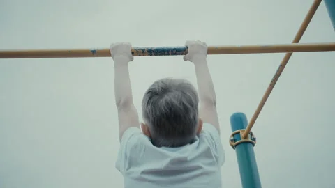The boy trains in pulling on the bar Stock Footage 109079517