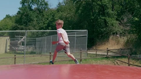 A Boy on a Trampoline Slow Motion Stock-Footage 345710922