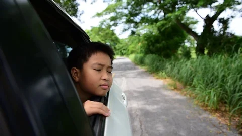Boy in a travelling car Stock Footage 76972585