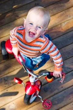 Boy on tricycle Stock Photos
