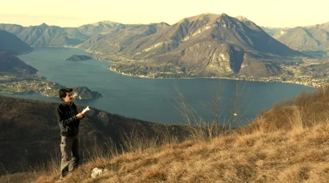 Boy tries to identify the different species of birds with the telescope Stock Footage 59551831